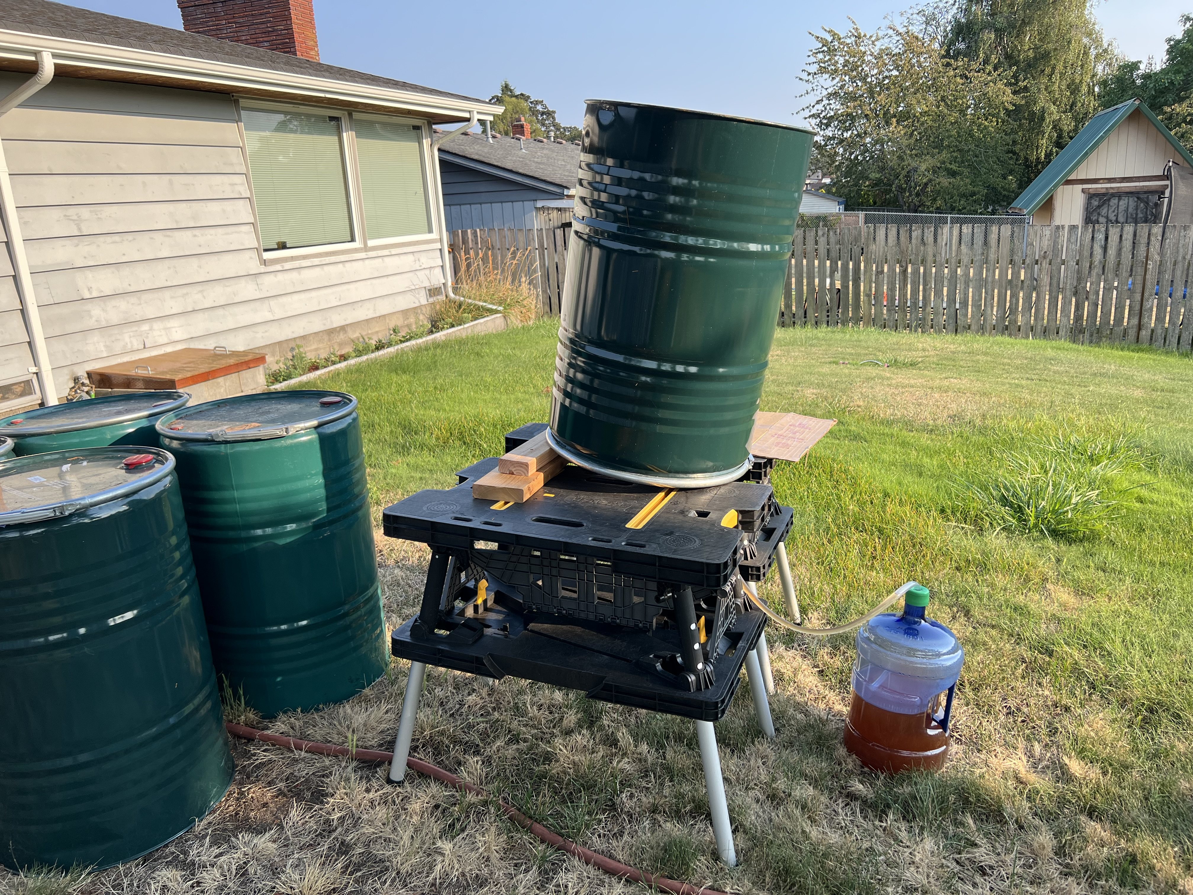 Draining the 76° coconut oil residue from the drums.  The sun helped.