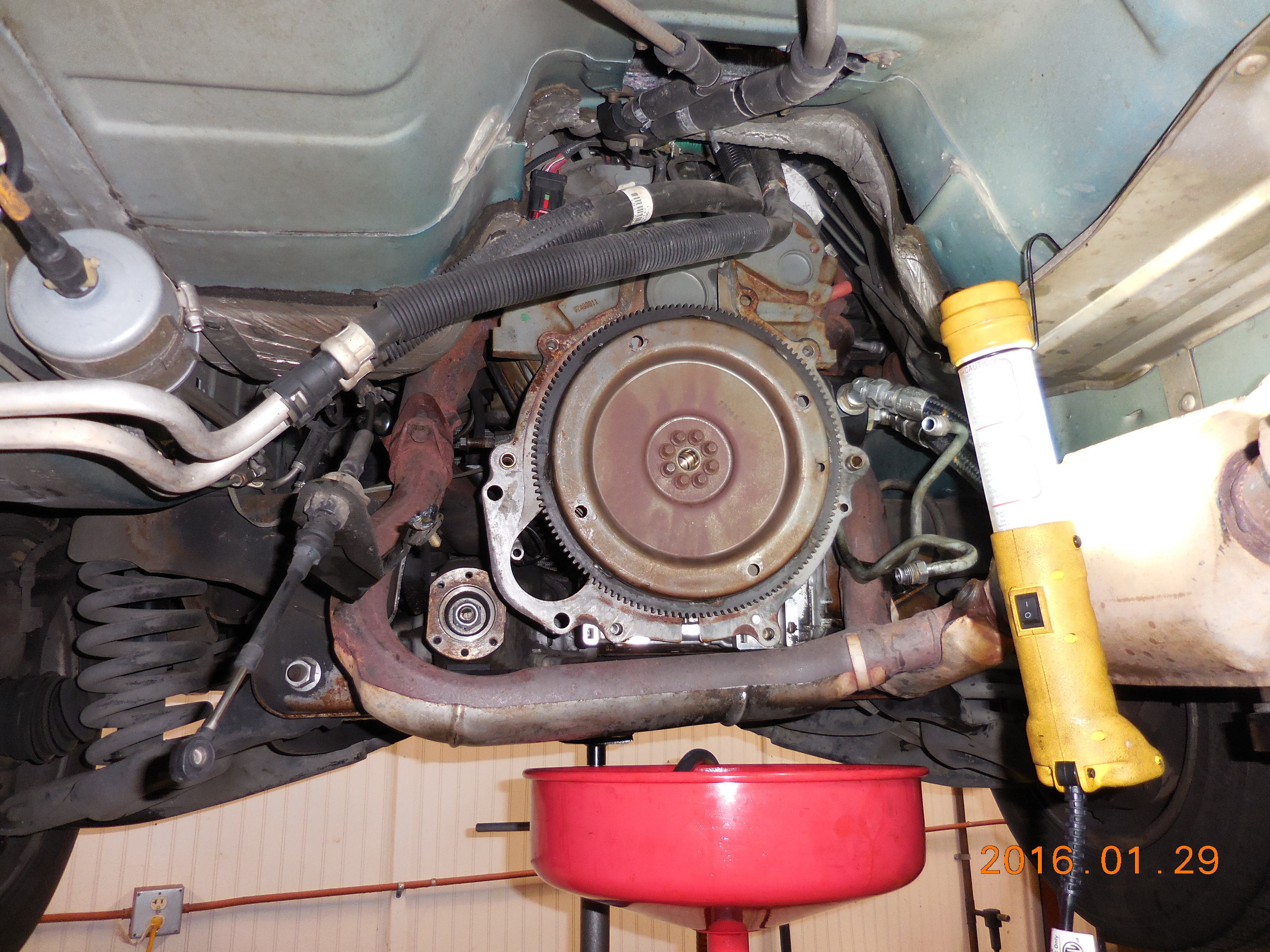 1997 Aerostar 4.0l OHV e4WD, trans & transfer case removed, showing dual A/C & dual heater lines that complicate transmission removal.