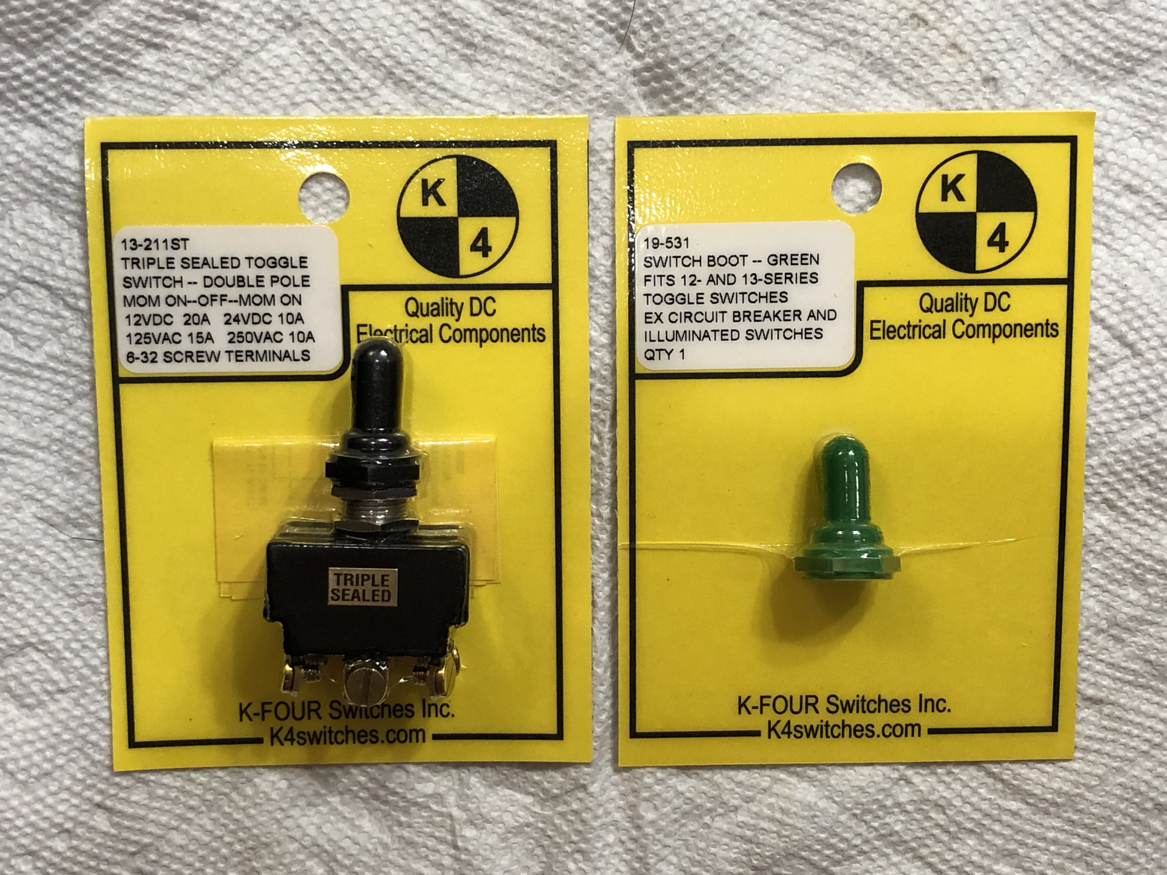 Switch, &quot;Triple Sealed&quot; DPDT (ON)-OFF-(ON), 20A, screw terminals, and weather cover.  Packaging view.