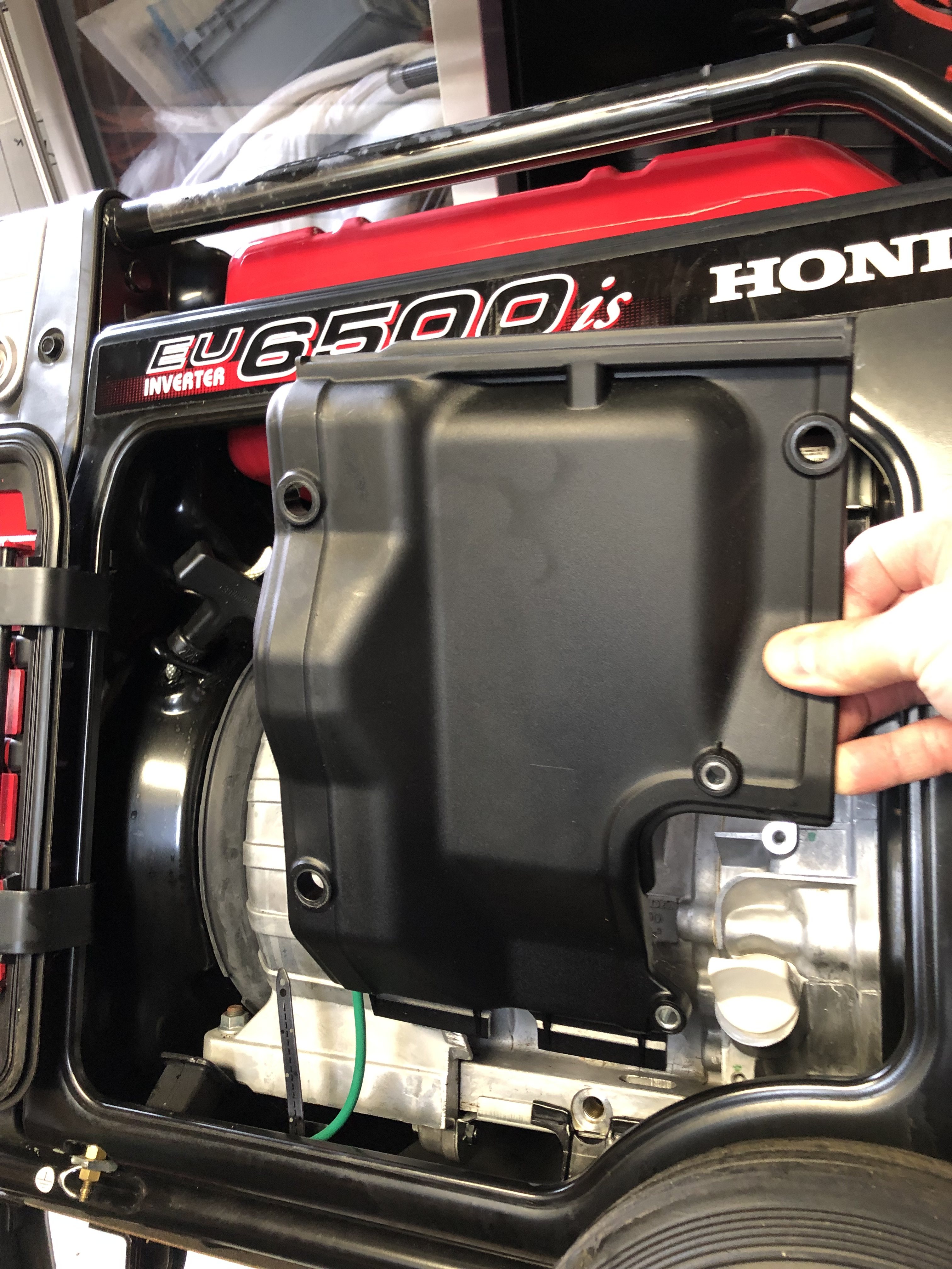 Honda EU6500iS, oil drain/fill side panel removed, showing sound baffle on GX390.