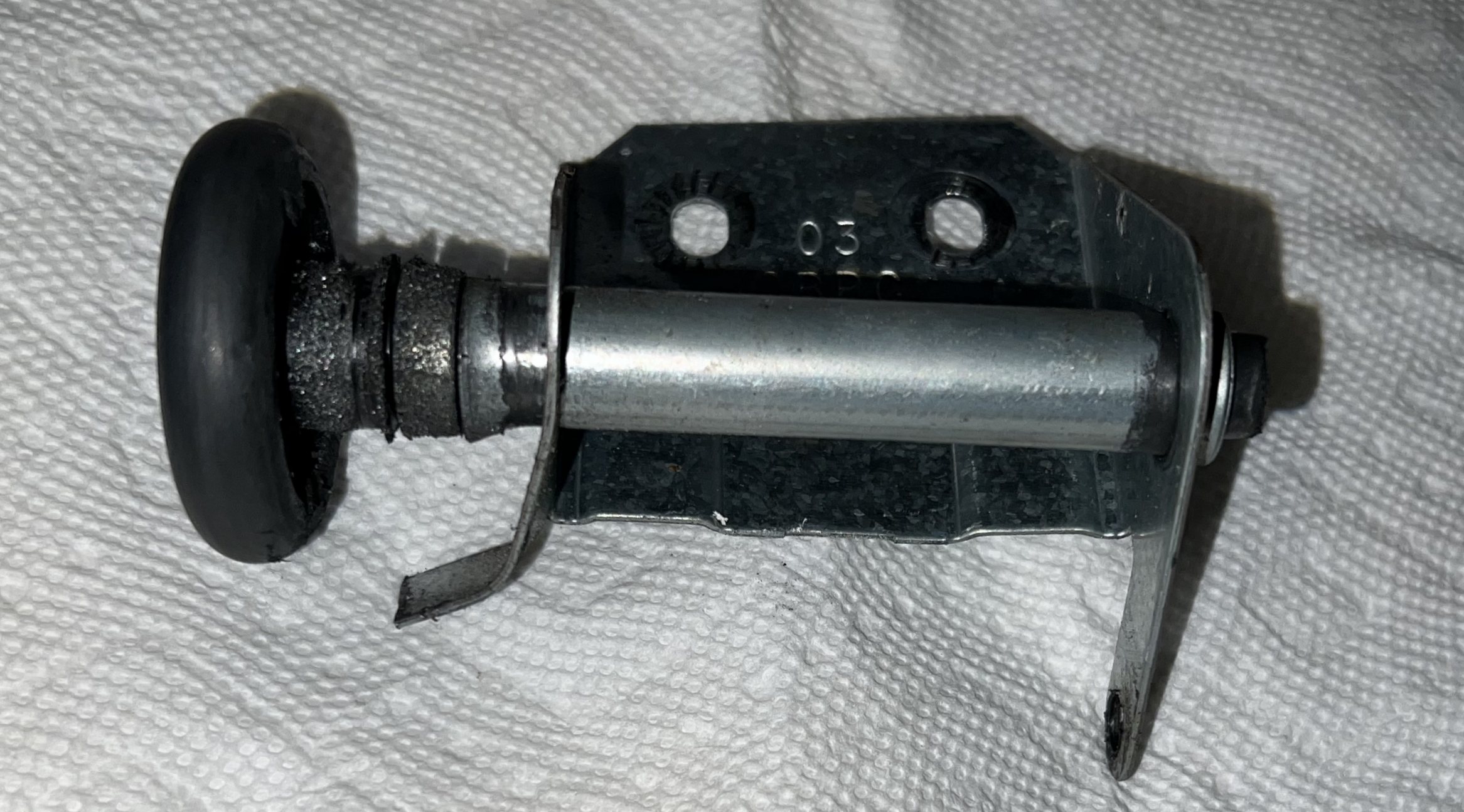 Damaged Clopay &quot;CBPC 03&quot; hinge with one arm bent and hinge pin end missing.