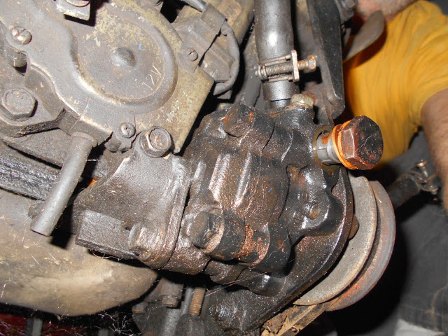 8. Power Steering pumps pulley and tensioner, different rear angle. <br />    Going up and over bolting to something in front of, under the oil pan area?