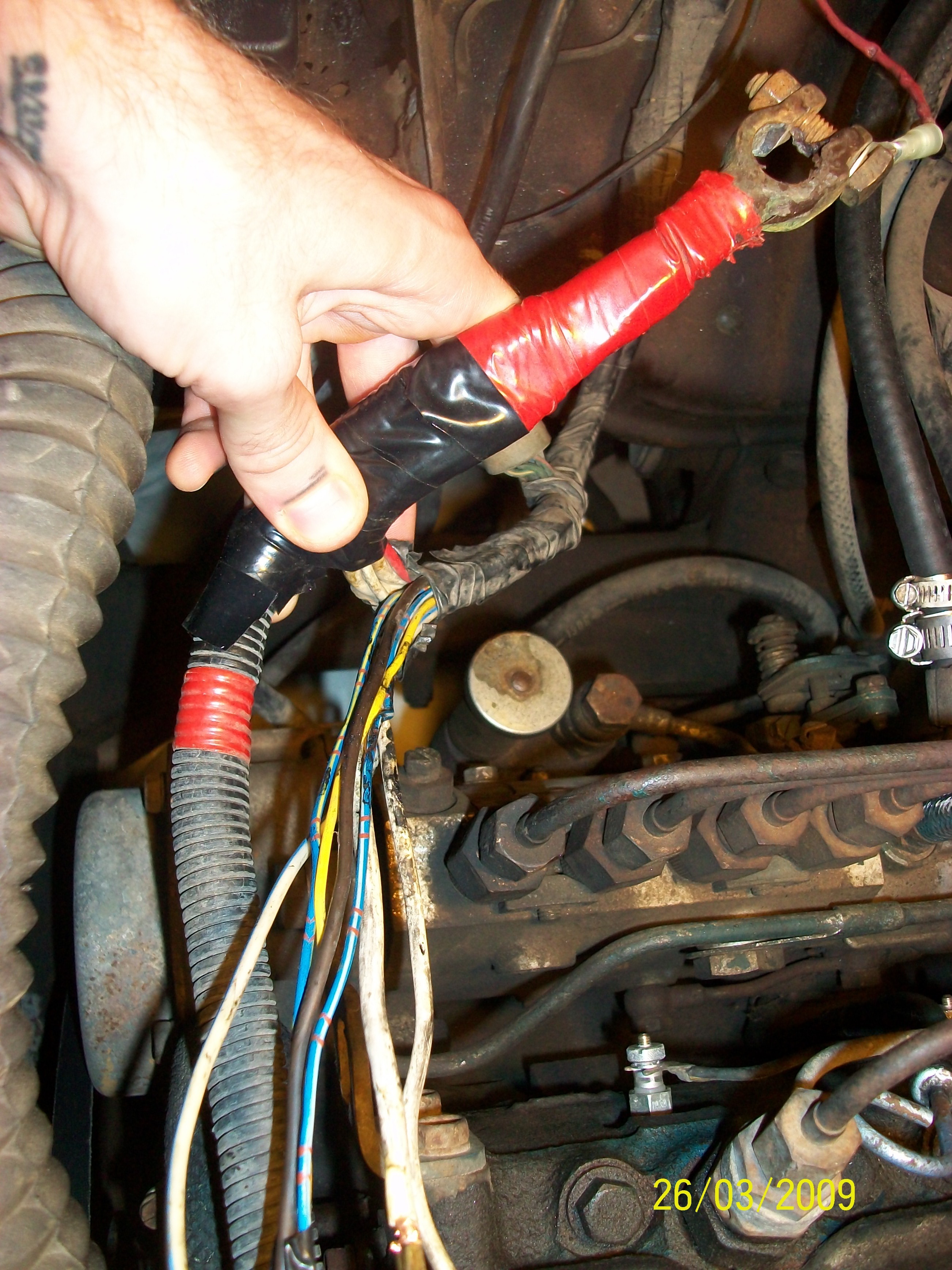 Photo 4: Here you can see the janky wiring set up that came with the truck. The blue &amp; white wire, mentioned above, is in the bunch to the right that goes down into a relay instead of connecting to the battery.