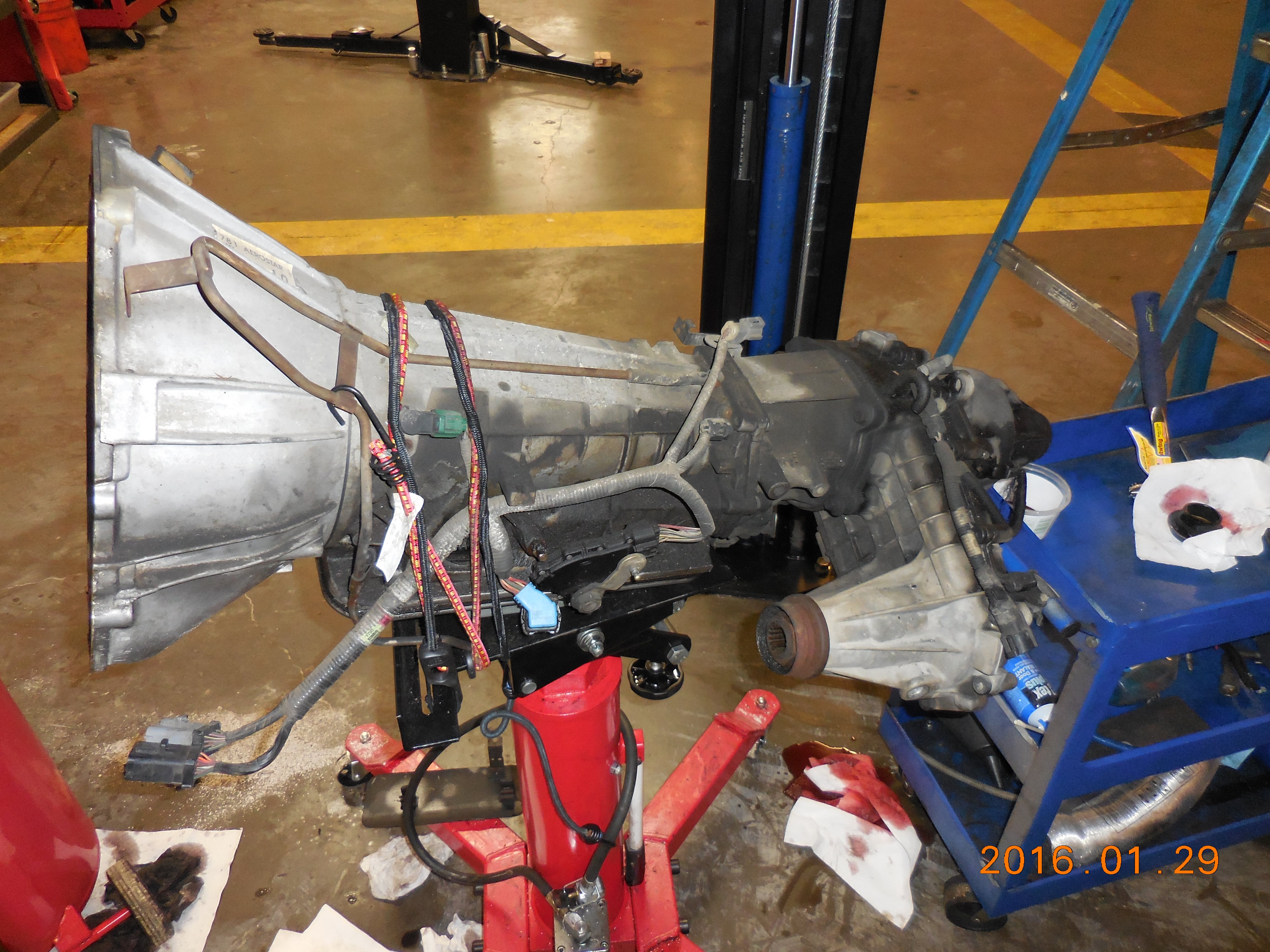 1997 Aerostar 4.0l OHV e4WD, trans & transfer case removed on transmission jack.  Not too dirty for 200k miles.