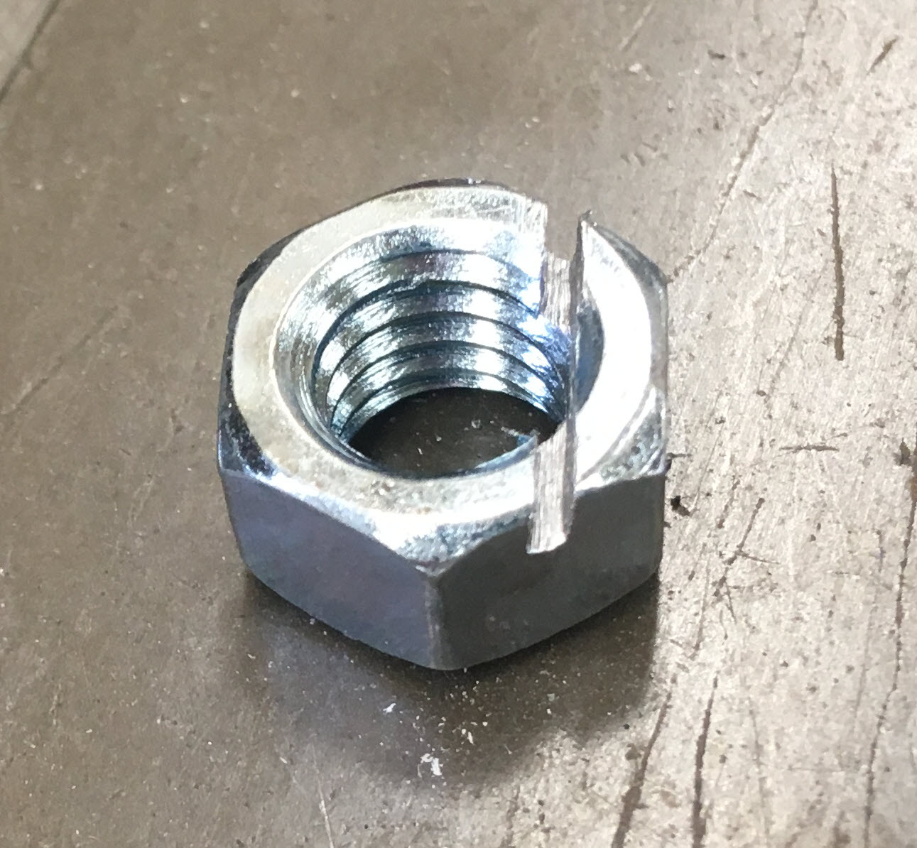 3/8&quot; hex nut after bandsaw treatment: offset slot.